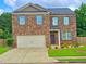 Charming two-story brick home with a well-manicured lawn and a two-car garage at 171 Shaker Hollow Drive Dr, Mcdonough, GA 30253