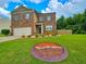 Brick and siding two-story home with a well-maintained yard and landscaping at 171 Shaker Hollow Drive Dr, Mcdonough, GA 30253