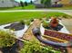Close up of landscaped yard with various rocks, plants, flowers, and healthy green grass at 171 Shaker Hollow Drive Dr, Mcdonough, GA 30253