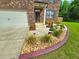 Home's front exterior with a well-kept yard, driveway, and nicely landscaped flower beds at 171 Shaker Hollow Drive Dr, Mcdonough, GA 30253