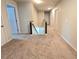 Upstairs hallway with neutral carpet, white walls, white doors, and dark railing overlooking the stairs at 171 Shaker Hollow Drive Dr, Mcdonough, GA 30253