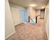 Upstairs hallway with neutral carpet, white walls, white doors, and dark railing overlooking the stairs at 171 Shaker Hollow Drive Dr, Mcdonough, GA 30253