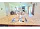 Beautiful kitchen island with sink overlooks the spacious dining and living areas at 171 Shaker Hollow Drive Dr, Mcdonough, GA 30253