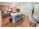 View of kitchen features an island, wooden cabinets, laminate floors and black appliances at 171 Shaker Hollow Drive Dr, Mcdonough, GA 30253