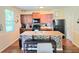 Cozy kitchen featuring an island with bar seating, wooden cabinetry, and modern appliances at 171 Shaker Hollow Drive Dr, Mcdonough, GA 30253