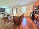 A modern kitchen features an island with granite countertop, wooden floors, and stainless steel appliances at 171 Shaker Hollow Drive Dr, Mcdonough, GA 30253