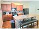 Inviting kitchen with wooden cabinets, granite countertops, mosaic backsplash and black appliances at 171 Shaker Hollow Drive Dr, Mcdonough, GA 30253