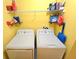 Efficient laundry area with a washer, dryer, and shelving for storage, designed for convenience at 171 Shaker Hollow Drive Dr, Mcdonough, GA 30253