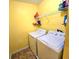 Functional laundry room featuring a washer, dryer, shelving, and ample space for sorting and folding at 171 Shaker Hollow Drive Dr, Mcdonough, GA 30253
