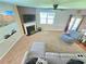 Spacious living room with a fireplace, ceiling fan, and ample natural light from the patio doors at 171 Shaker Hollow Drive Dr, Mcdonough, GA 30253