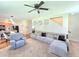 Inviting living room featuring a comfortable sectional sofa, ceiling fan, and adjacent kitchen area at 171 Shaker Hollow Drive Dr, Mcdonough, GA 30253
