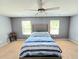 Spacious main bedroom with neutral carpet, ceiling fan, and ample natural light at 171 Shaker Hollow Drive Dr, Mcdonough, GA 30253