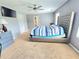 Spacious main bedroom with neutral carpet, ceiling fan, workspace, and ample natural light at 171 Shaker Hollow Drive Dr, Mcdonough, GA 30253