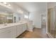 Large bathroom boasts double sinks, a shower, and wood-look floors at 237 Arwen Drive Lot 61, Mcdonough, GA 30252