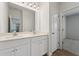 Bright bathroom featuring a double sink vanity and a large mirror with modern lighting at 237 Arwen Drive Lot 61, Mcdonough, GA 30252