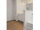 Bathroom featuring wood floors, a large vanity, and a bathtub with shower at 237 Arwen Drive Lot 61, Mcdonough, GA 30252