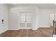 Bright foyer with wood floors, white walls, and glass French doors leading to another room at 237 Arwen Drive Lot 61, Mcdonough, GA 30252