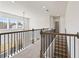 Upstairs hallway with wooden bannister and multiple windows at 237 Arwen Drive Lot 61, Mcdonough, GA 30252