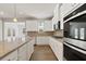 Modern kitchen featuring granite countertops, white cabinets, stainless steel appliances, and pendant lighting at 237 Arwen Drive Lot 61, Mcdonough, GA 30252