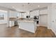 Modern kitchen featuring white cabinets, stainless steel appliances, and a center island with granite countertops at 237 Arwen Drive Lot 61, Mcdonough, GA 30252