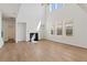 Bright, open living room with high ceilings, a fireplace, and large windows at 237 Arwen Drive Lot 61, Mcdonough, GA 30252