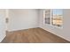 Bright, empty room with wood floors, white walls, baseboard trim and a large window at 237 Arwen Drive Lot 61, Mcdonough, GA 30252