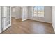 Bright, empty room with wood floors, white walls, baseboard trim, French doors, and a large window at 237 Arwen Drive Lot 61, Mcdonough, GA 30252