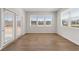 Bright sun room with wood floors, white walls, baseboard trim, and large sliding glass doors at 237 Arwen Drive Lot 61, Mcdonough, GA 30252