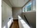 Bright upstairs hallway with hardwood floors, storage closet, and natural light at 970 Bibbs Circle Nw # 12, Atlanta, GA 30318