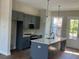 Modern kitchen boasts sleek gray cabinets, an island, and stainless steel appliances at 970 Bibbs Circle Nw # 12, Atlanta, GA 30318