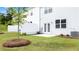 Charming backyard with a lush green lawn, patio area and fresh landscaping at 235 Silver Moon Dr, Loganville, GA 30052