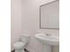 Powder room with toilet and pedestal sink under the mirror at 235 Silver Moon Dr, Loganville, GA 30052