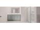 Bathroom featuring a double vanity, framed mirror, and a shower with glass doors at 235 Silver Moon Dr, Loganville, GA 30052