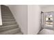 Bright entryway with staircase and open door, creating an inviting atmosphere at 235 Silver Moon Dr, Loganville, GA 30052