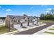 Townhomes with gray roofs, brick, and attached garages, surrounded by green lawns at 235 Silver Moon Dr, Loganville, GA 30052