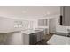 Open kitchen with island, modern appliances, and hardwood flooring; flows into living area at 235 Silver Moon Dr, Loganville, GA 30052