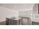 Bright, open kitchen with stainless appliances, island with sink, and hard surface counter at 235 Silver Moon Dr, Loganville, GA 30052