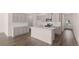 Open concept kitchen with modern island, stainless steel appliances, and ample cabinetry at 235 Silver Moon Dr, Loganville, GA 30052