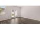 Living room with hardwood floors, a window, and a door to the backyard at 235 Silver Moon Dr, Loganville, GA 30052