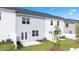 Townhome exterior featuring a green lawn, white fence, patio, and new landscaping at 255 Silver Moon Dr, Loganville, GA 30052