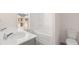 Bright bathroom with double sink vanity, white cabinets, garden tub, and a window at 255 Silver Moon Dr, Loganville, GA 30052
