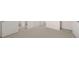 Hallway with neutral colored carpet, white walls, and multiple white paneled doors at 255 Silver Moon Dr, Loganville, GA 30052