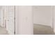 Bright hallway featuring neutral-colored walls, plush carpeting, and paneled doors at 255 Silver Moon Dr, Loganville, GA 30052