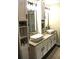 Bathroom featuring double sinks, modern fixtures, and ample cabinet storage at 3824 Smith Creek Ct, Buford, GA 30519