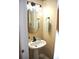 Cozy bathroom features a pedestal sink, modern lighting, and neutral wall color at 3824 Smith Creek Ct, Buford, GA 30519