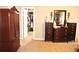A bedroom featuring dark wood furniture and a glimpse into a well-organized walk-in closet at 3824 Smith Creek Ct, Buford, GA 30519