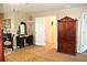 Primary suite boasts a vanity area, armoire, and neutral carpeting at 3824 Smith Creek Ct, Buford, GA 30519