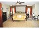 Spacious primary bedroom featuring a four-poster bed and stylish furnishings at 3824 Smith Creek Ct, Buford, GA 30519
