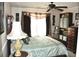 Comfortable bedroom with patterned lamp, side table, and large window at 3824 Smith Creek Ct, Buford, GA 30519