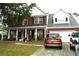 Charming two-story brick home with well-maintained landscaping and inviting front porch at 3824 Smith Creek Ct, Buford, GA 30519
